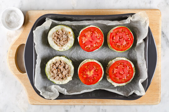 Zucchini stuffed with minced meat and rice, with tomatoes and mozzarella. Step-by-step cooking