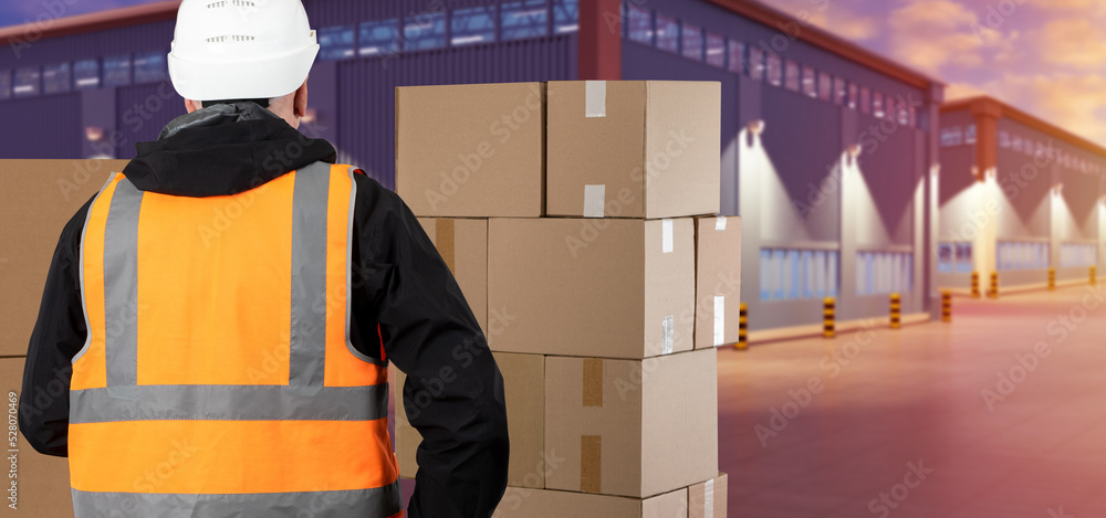 Poster warehouse processes. warehouse worker with his back to camera. man and boxes in front of buildings. 