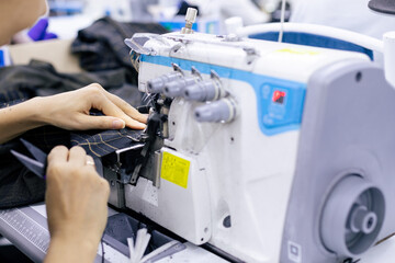 Tailor working on electric sewing machine