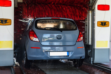 Automatic car wash. Auto brush washer clean blue car on automatic carwash station. Automatic car...