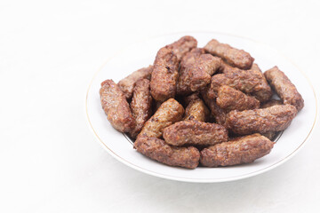 Grilled Kebabs served on the plate with copy space above white background