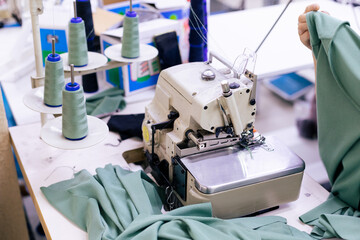 Tailor working on electric sewing machine