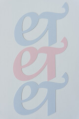 logogram et in pink and blue on blank paper