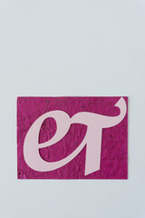 logogram et in pink on blank paper