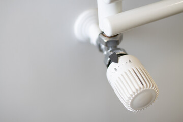 Adjust a thermostatic valve to save energy. Energy saving in domestic heating by reducing the power...