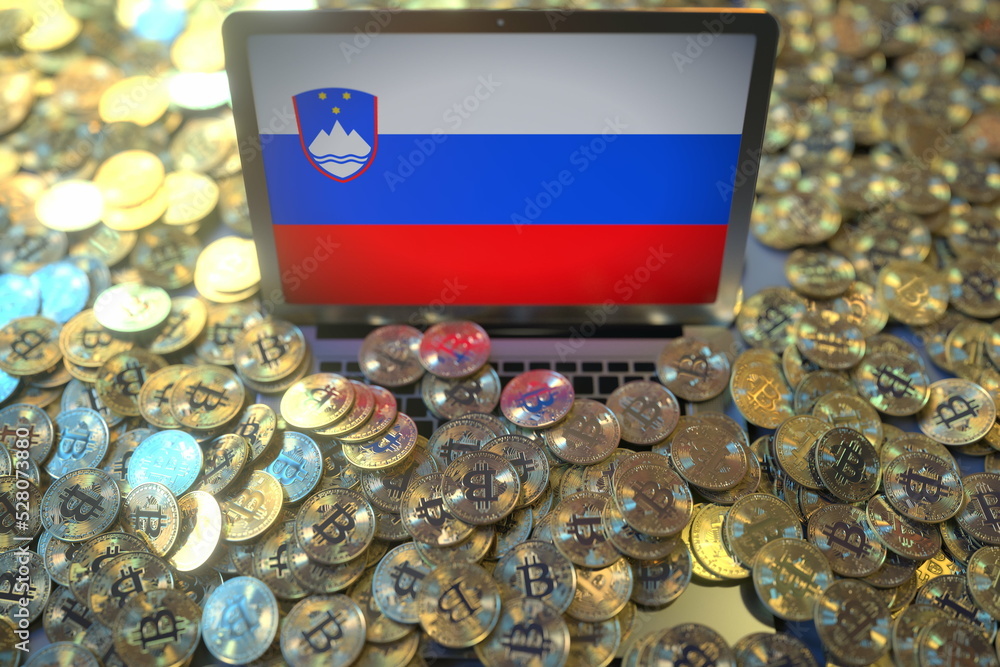 Poster computer with flag of slovenia and pile of bitcoins. national regulations and cryptocurrency mining 