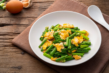 Stir Fried Onion Flower Stem with egg in white plate.easy food