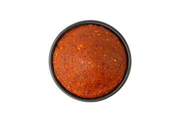 Thai red curry paste in black bowl isolated on white background with clipping path.Top view