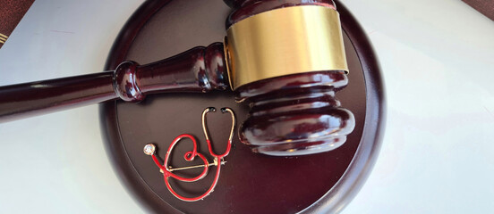 Judicial gavel and stethoscope medical crimes closeup