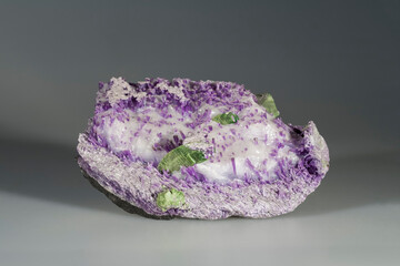 A sample of a natural mineral Chromium Titanite (titanium and calcium silicate) wedge-shaped crystals in calcite with amesite on chlorite. Museum Mineral Series. Mineralogical sample