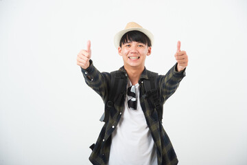 Happy Asian young man traveler wearing hat and sunglasses thump up isolated on white background studio. Lifestyle traveling