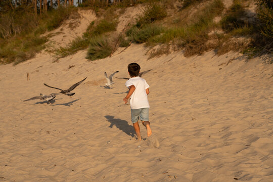Sarbinowo poland August 2022, unidentfied children play by the Baltic sea in the evening