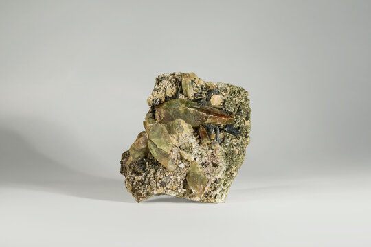 A sample of a natural mineral Sphene or Titanite green-orange crystals, titanium and calcium silicate, epidote, quartz. Museum Mineral Series. Mineralogical sample
