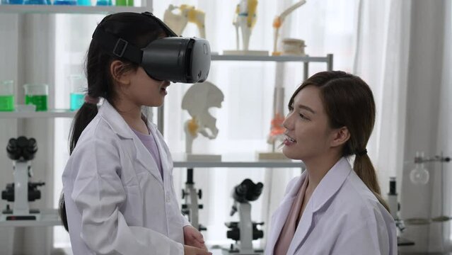 Asian Teacher Teaching Young Child to Learn Science From Virtual Reality