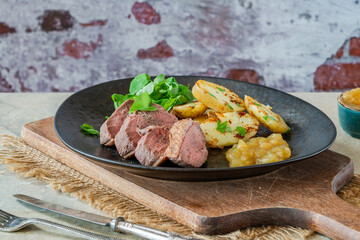 Roasted dack breast with fried potatoes and apple sauce