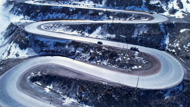 Highway road with scenic curves winding road at Andes Mountains. Los Caracoles highway road near Santiago Chile. Snowing scenery. Snowing road. Curves background. Curves road.
