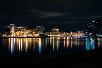 Skyline of Malmö Sweden seen from the water with lights reflecting