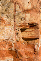 Sedimentary rocks with a high content of iron oxide. Red soil, loam. The texture of the soil.