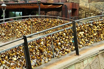 A large number of locks on the railing of the bridge symbolizing a strong love union