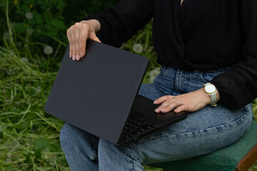 woman opens laptop, work online, outdoors, business woman