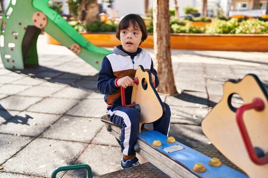 Down syndrome kid playing at park