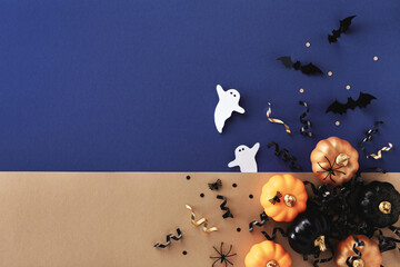 Halloween holiday card with party decorations of pumpkins, bats, ghosts on gold blue background top...