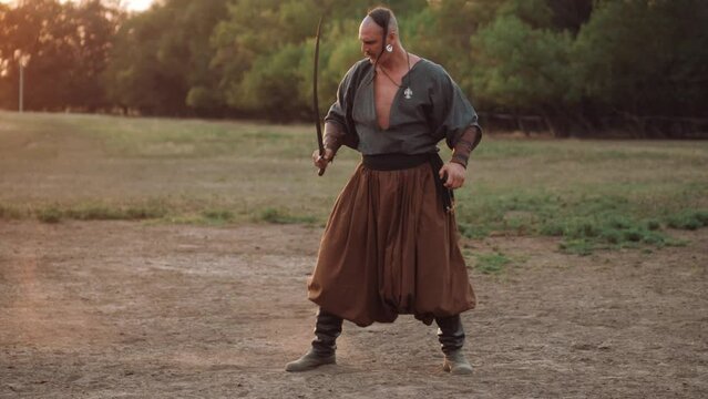 Zaporizhian Cossack with a saber in his hands is preparing for battle. Independent Ukrainian people. Patriots of their country.