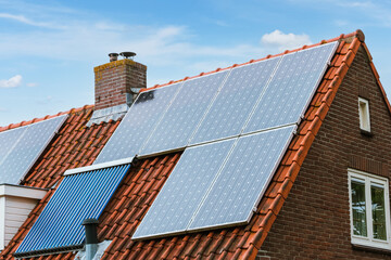 Fototapeta premium House with solar panels on the roof. Modern ecological energy resource. Green energy by sun.