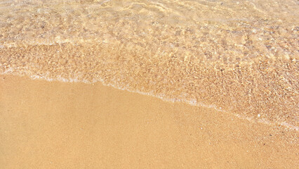 Fototapeta na wymiar waves on the beach sand beach