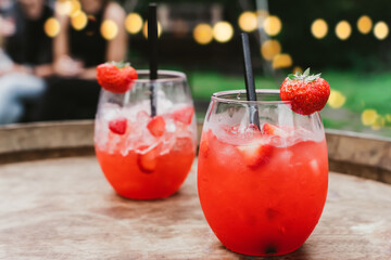 Red strawberry daiquiri cocktail or mocktail in glass with drinking straw. Refreshing summer drink for party or festive.