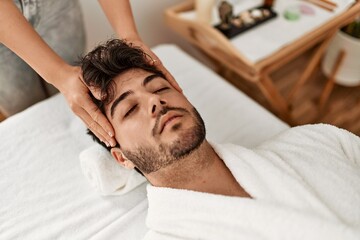 Fototapeta na wymiar Man relaxed reciving head massage at beauty center.
