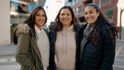 Obraz premium Mother and daugthers smiling confident hugging each other at street