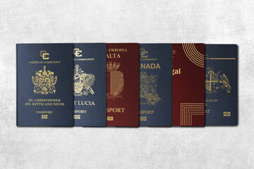Top View, International Passports, citizenship by Investment, Nationality, Malta, Kitts and Nevis, Portugal,grenada, Dominica, Saint Lucia On a concrete wall - obrazy, fototapety, plakaty