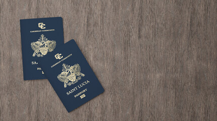 Saint Lucia passport on a wooden board, Citizenship by Investment, close-up - obrazy, fototapety, plakaty