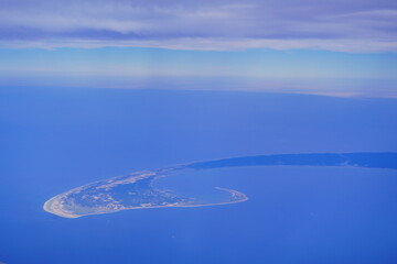 an aerial view of Cape Cod, city view and beach and ocean view from airplane. Cape Cod, a hook-shaped peninsula of the U.S. state of Massachusetts, is a popular summertime destination.