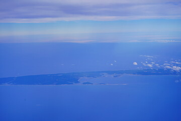 an aerial view of Cape Cod, city view and beach and ocean view from airplane. Cape Cod, a hook-shaped peninsula of the U.S. state of Massachusetts, is a popular summertime destination.
