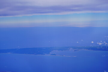 Fototapeta premium an aerial view of Cape Cod, city view and beach and ocean view from airplane. Cape Cod, a hook-shaped peninsula of the U.S. state of Massachusetts, is a popular summertime destination.
