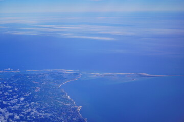 an aerial view of Cape Cod, city view and beach and ocean view from airplane. Cape Cod, a hook-shaped peninsula of the U.S. state of Massachusetts, is a popular summertime destination.