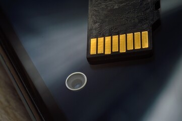 micro sd card lies on the smartphone screen. close-up