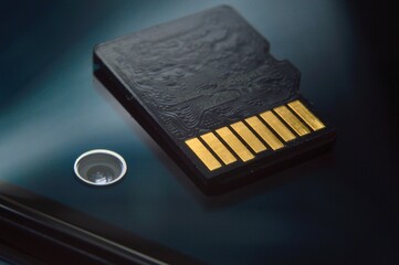 micro sd card lies on the smartphone screen. close-up