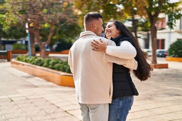 Man and woman smiling confident dancing at park