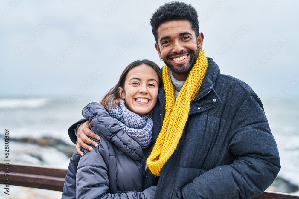 Canvas Prints Man and woman couple smiling confident hugging each other at seaside