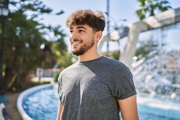 Young arab man smiling happy standing at the city.