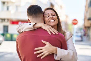 Fototapeta premium Man and woman mother and son hugging each other at street