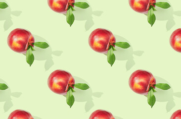 Pattern of nectarines on green pastel background