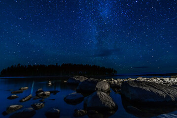 night landscape with a starry sky and Milky way with many bright stars. Astrophotography with...