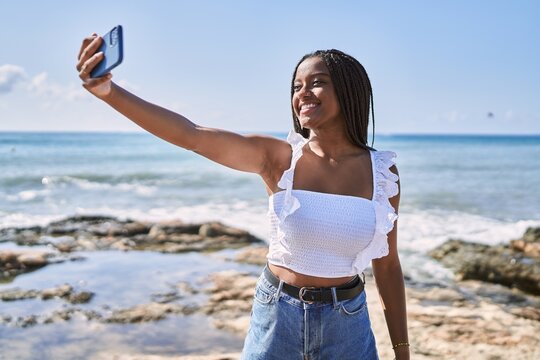 Young african american girl smiling happy make selfie by the smartphone at the beach.