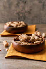 Image of bunch of peanuts in a bowl on a wooden table