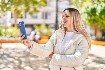 Young woman smiling confident having video call at park