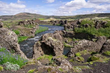 Fototapeta na wymiar Top part of Hjalparfoss waterfall and basalt rocks in Iceland